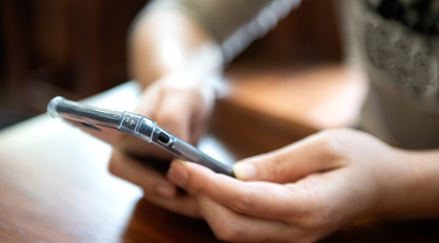 Young girl is playing a smartphone.