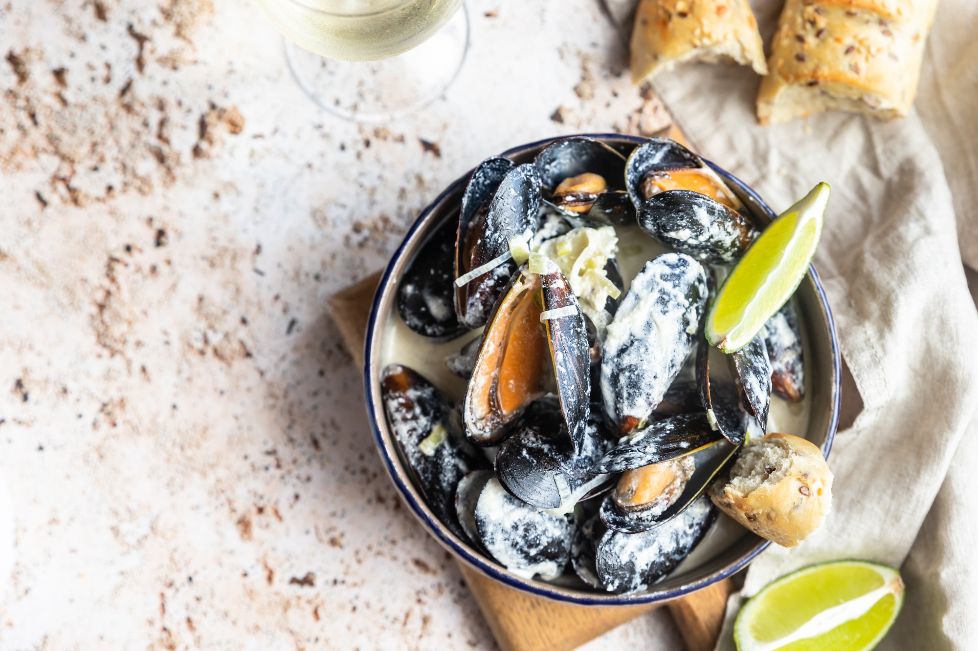 Blue mussels in wine sauce with lime and bread. Stew mussels in wine, leek and blue cheese. Seafood