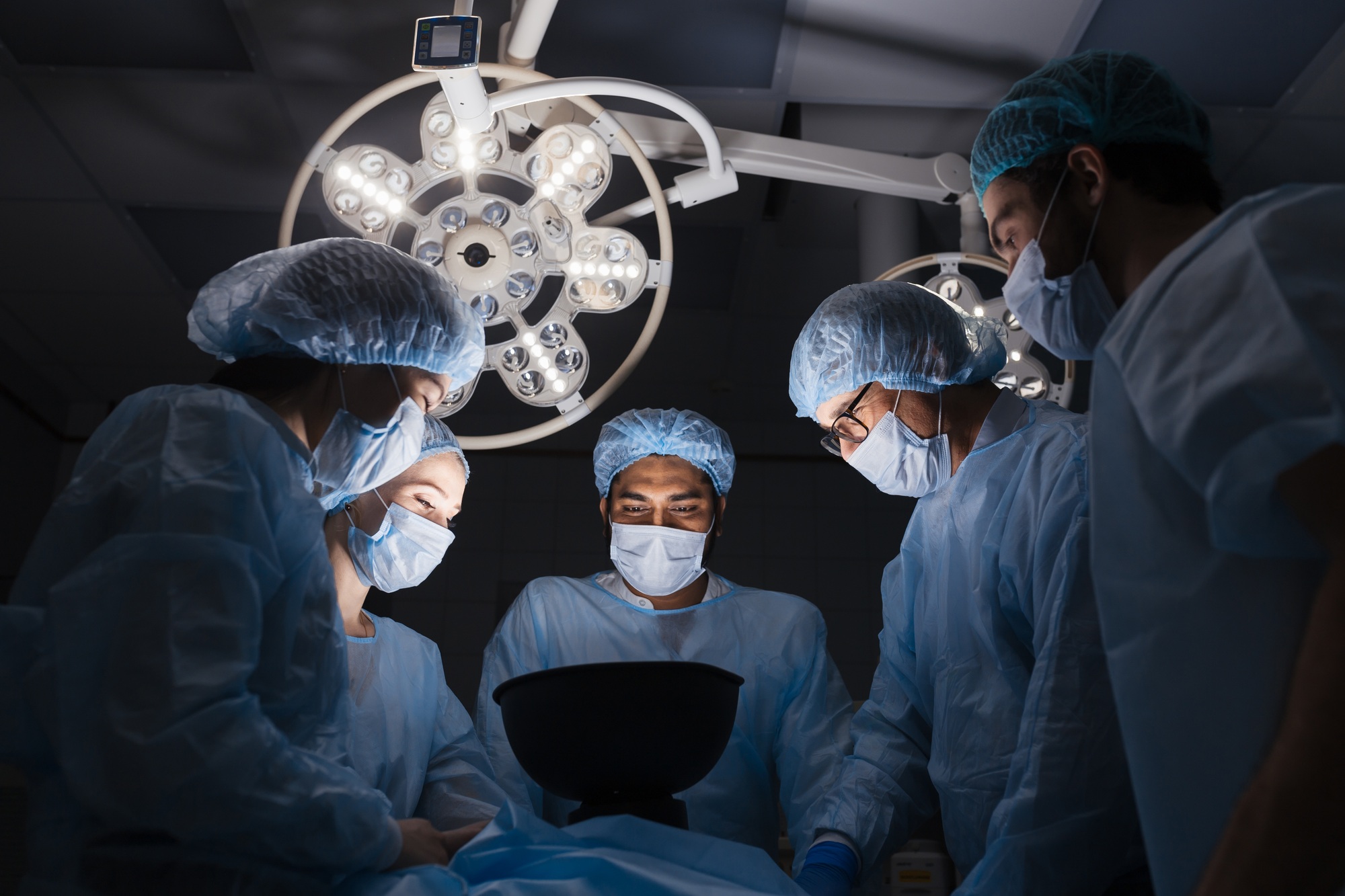 Diverse Team of surgeon, assistants and nurses making invasive surgery