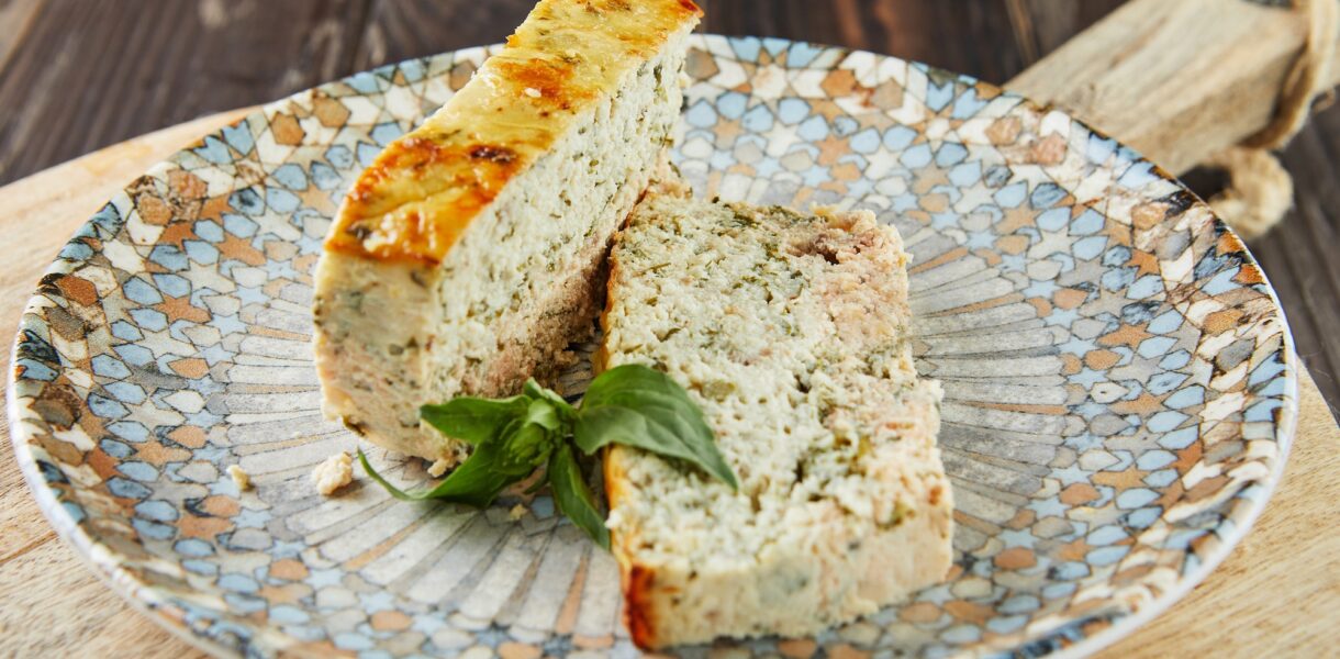 Salmon and dennis pate, sliced slices on plate of basil. French gourmet cuisine