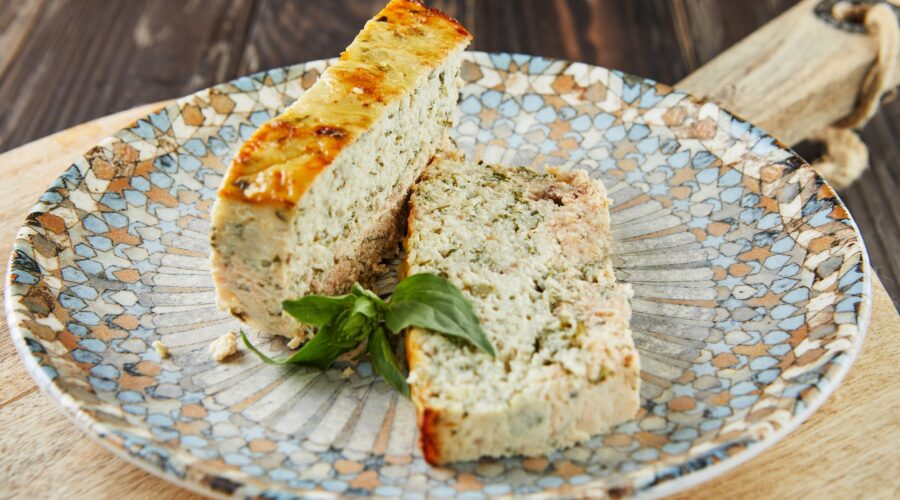 Salmon and dennis pate, sliced slices on plate of basil. French gourmet cuisine