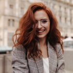 Young woman in good humor poses outside