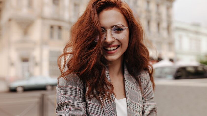 Young woman in good humor poses outside