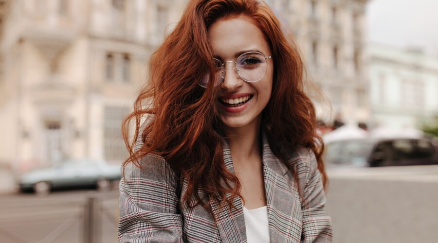Young woman in good humor poses outside