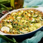 Zucchini casserole with eggs, milk, cheese and greens herbs